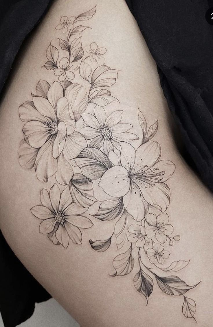 a woman's thigh with flowers on it