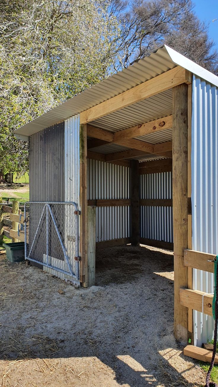 a horse barn with two stalls attached to it