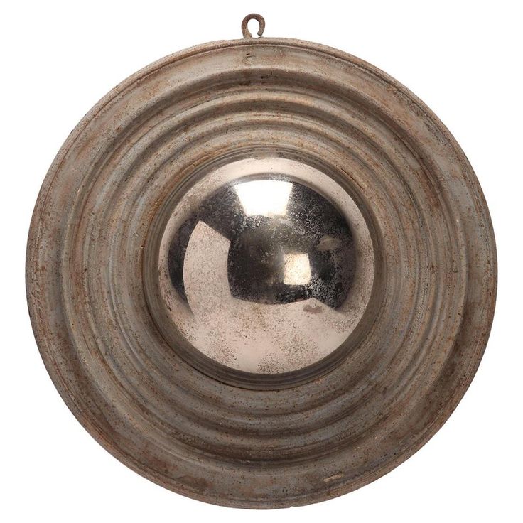 a round metal object hanging from a chain