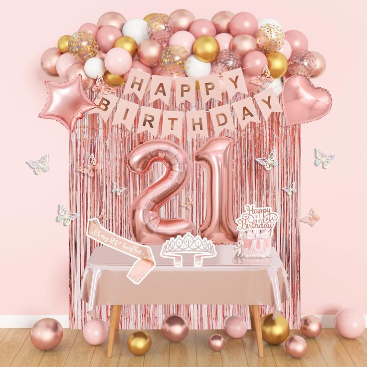 a pink 21st birthday party with balloons and streamers