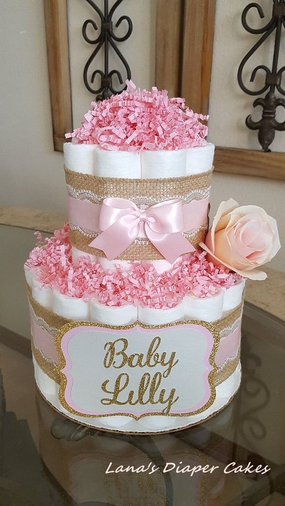 a three tiered cake decorated with pink flowers