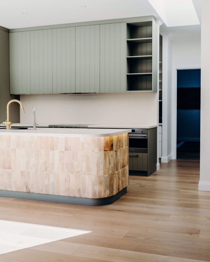 a kitchen with wooden floors and white walls