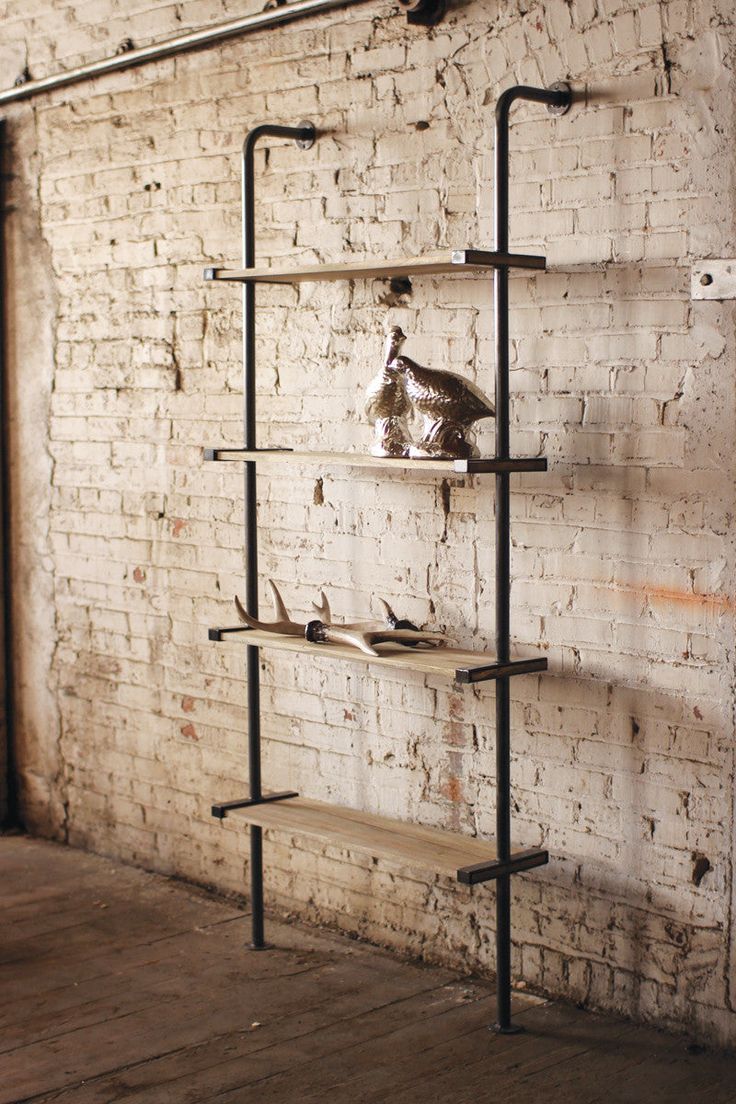 an old brick wall with some shelves and shoes on it in front of a white brick wall