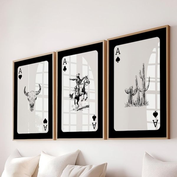 three black and white pictures hang on the wall next to a bed with two pillows