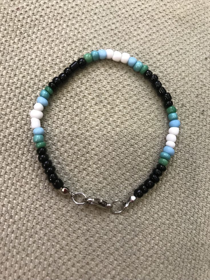 a bracelet with black, white and blue beads