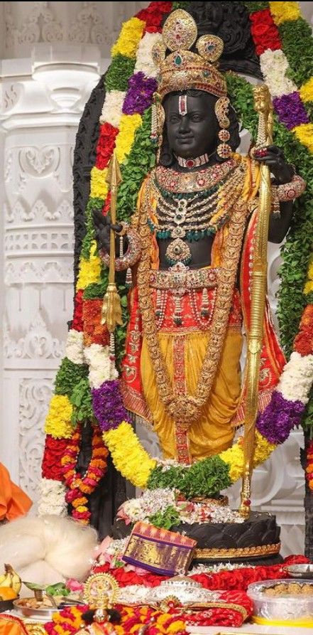 the statue is decorated with flowers and garlands