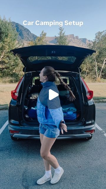 a woman walking into the trunk of a car