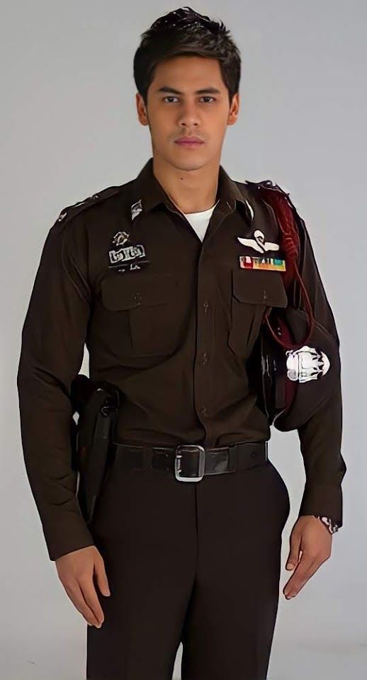 a man in uniform is posing for the camera with his hands on his hips and one hand on his hip