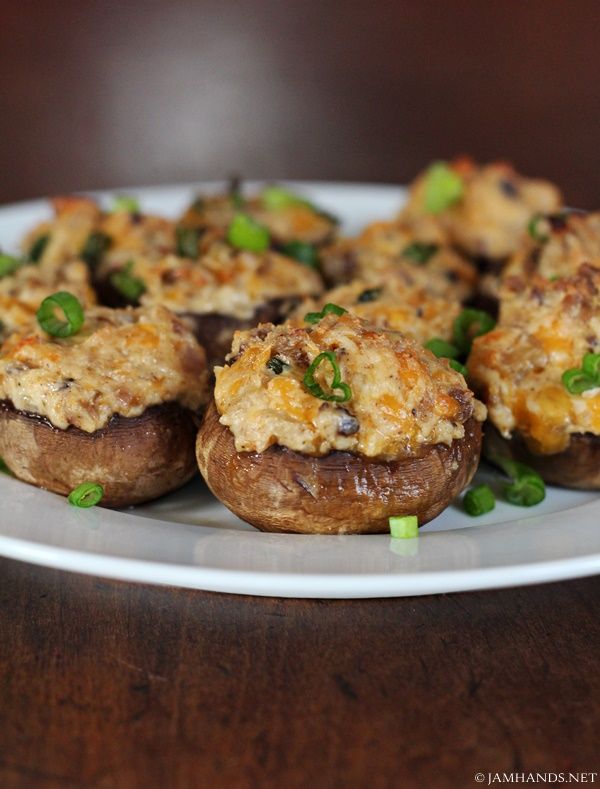 some stuffed mushrooms are sitting on a white plate