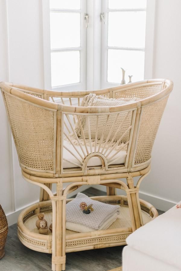 a wicker baby crib in the corner of a room