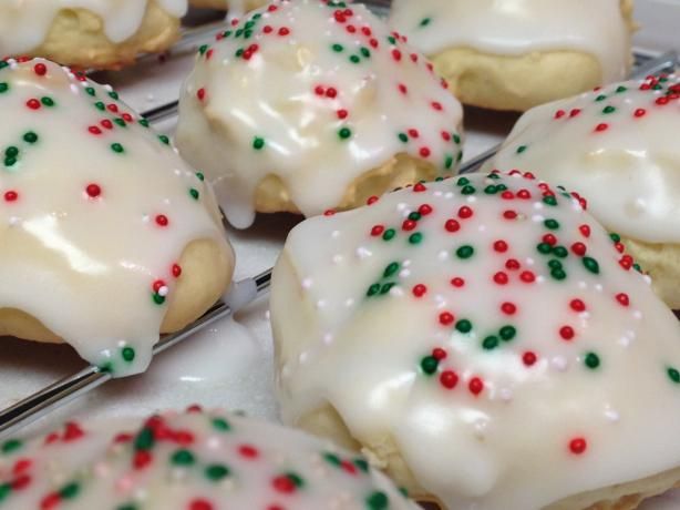 there are many cookies with white icing and sprinkles on the tray