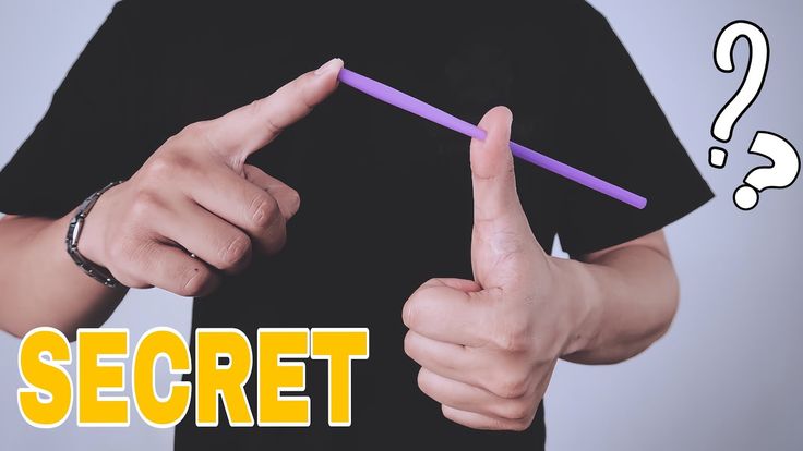 a man holding a pencil and pointing to the word secret on his left hand with question marks above it