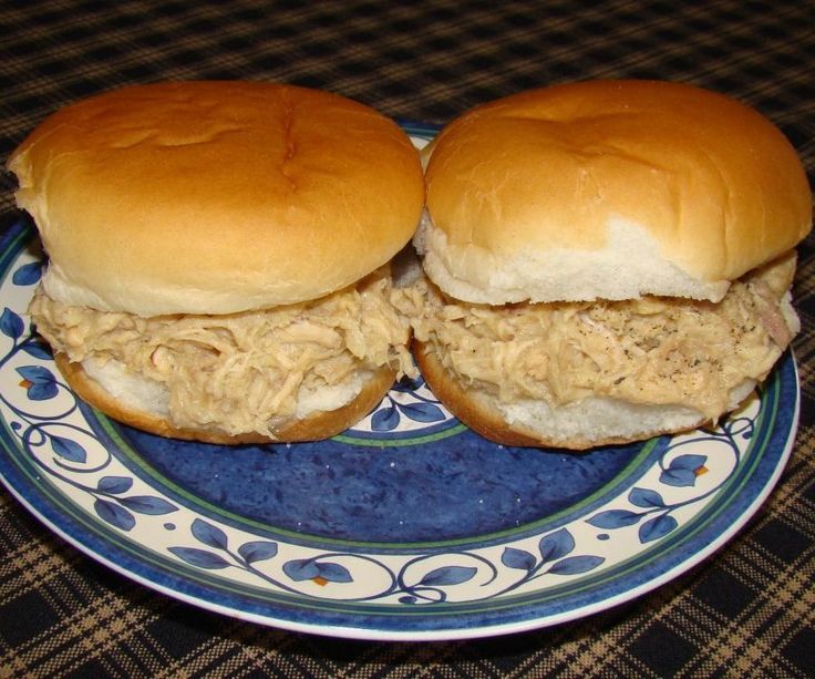 two pulled pork sandwiches on a blue and white plate