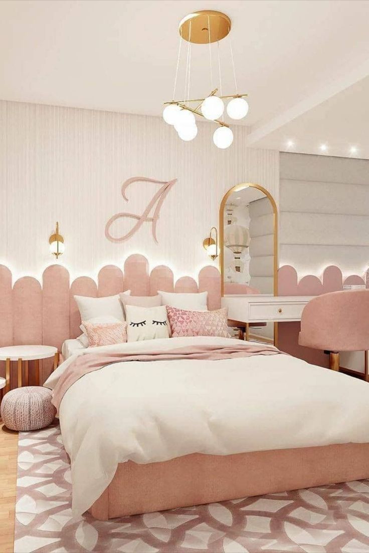 a bedroom decorated in pink and white with gold accents