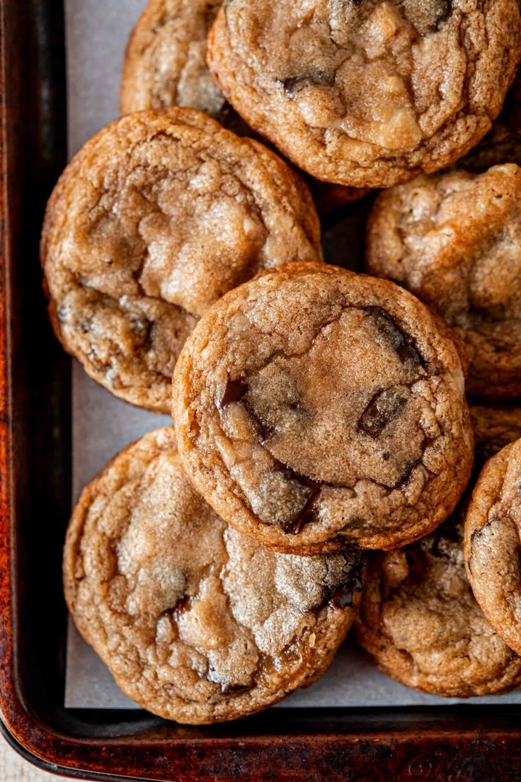 chocolate chip cookies are piled up in a tray