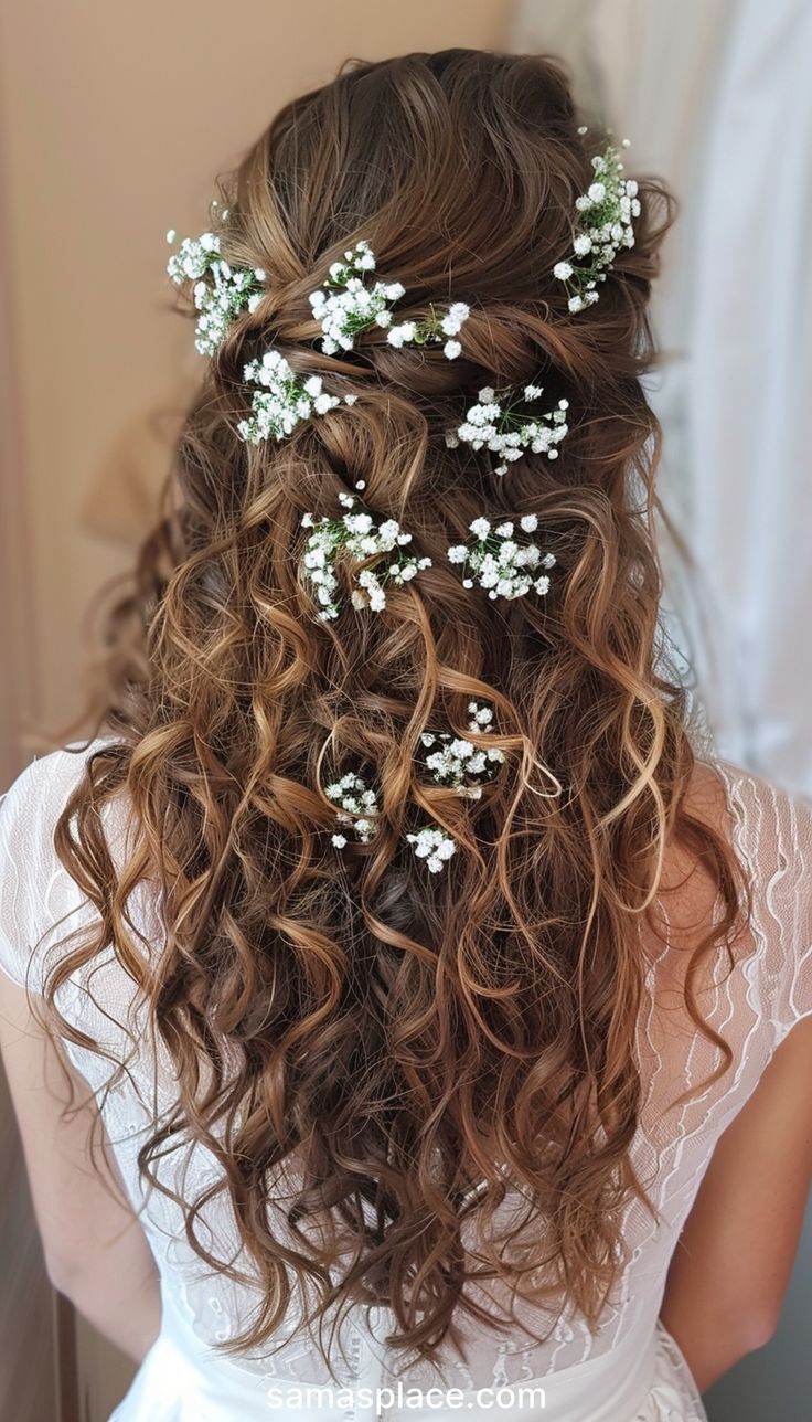 This half-up, half-down style features soft, cascading curls adorned with sprigs of baby's breath. The upper section of hair is gently pulled back, creating a subtle lift and adding volume. The overall effect is both elegant and effortless, making it a versatile choice for various formal occasions. Long Curly Hair Down Wedding, Bride Hairstyle For Curly Hair, Long Hair Curly Wedding Hairstyles, Flower Crown Wedding Curly Hair, Medium Curly Wedding Hair, Curly Wedding Hair With Flowers, Bride Hairstyles Curly Hair Down, Long Curly Hair Bridal Hairstyles, Curly Bridal Hair Half Up