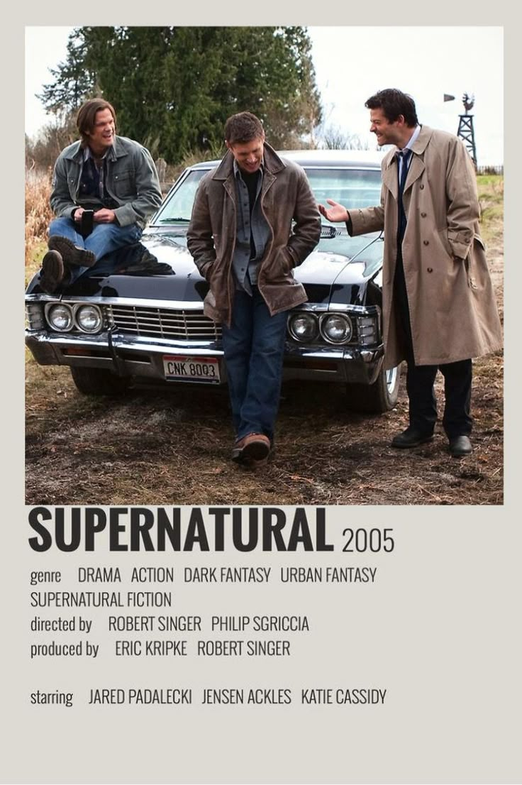 two men standing next to a car with the words supernatural on it and another man sitting on top