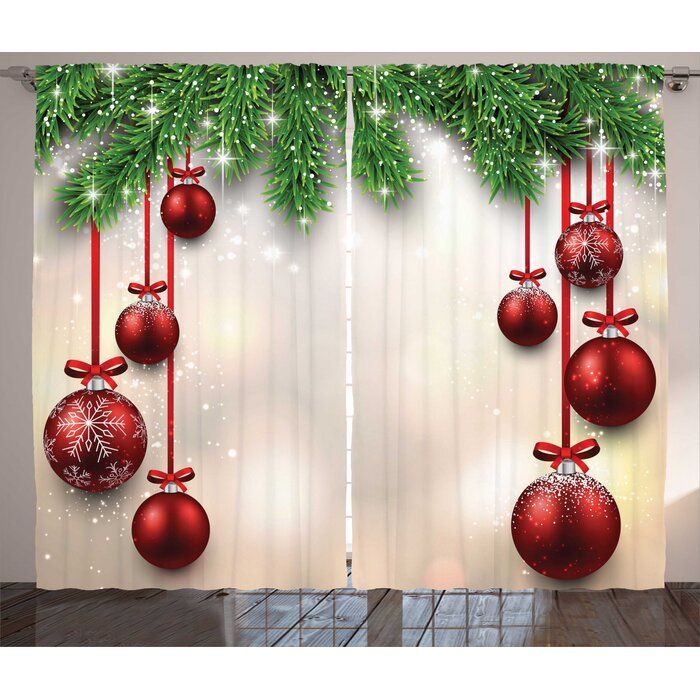 christmas decorations hanging from the side of a window with red balls and bows on them