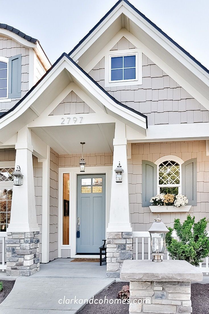 the front entrance of a house with blue doors and windows