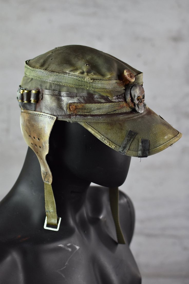 Postapoc Cap - Military Style Cap - Wasteland LARP Headpiece - Army Green Cap - LARP Accessories - Post Apocalyptic Hat - Handmade Headwear A unique post-apocalyptic styled cap. An olive green base, decorated with leather straps and stylish ear flaps. It's a unique costume piece that will add a spark of life to any military-style outfit! Finished with professional paintwork for a distressed effect, it has a very lifelike feel of a worn down headpiece. It's a one size product. More apocalyptic clothing: https://etsy.me/3Z2OHJ5 More accessories: https://etsy.me/2jskDVG MY ETSY SHOP: https://www.etsy.com/shop/WastedCouture Wear if you dare! --------------------------------------------------------------------- Wasted - Wasted Couture - WastedCouture Alternative Style Adjustable Cap, Adjustable Alternative Style Cap, Military Style Outfits, Larp Accessories, Apocalypse Clothing, Apocalyptic Clothing, Army Hat, Apocalyptic Fashion, Green Cap