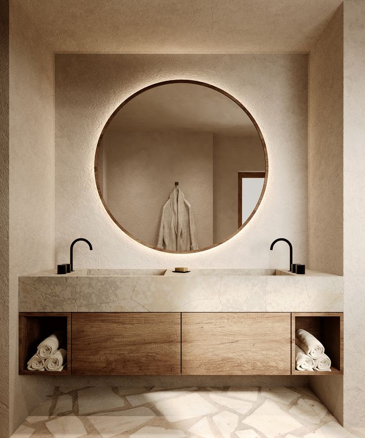 a bathroom with a large round mirror above the sink