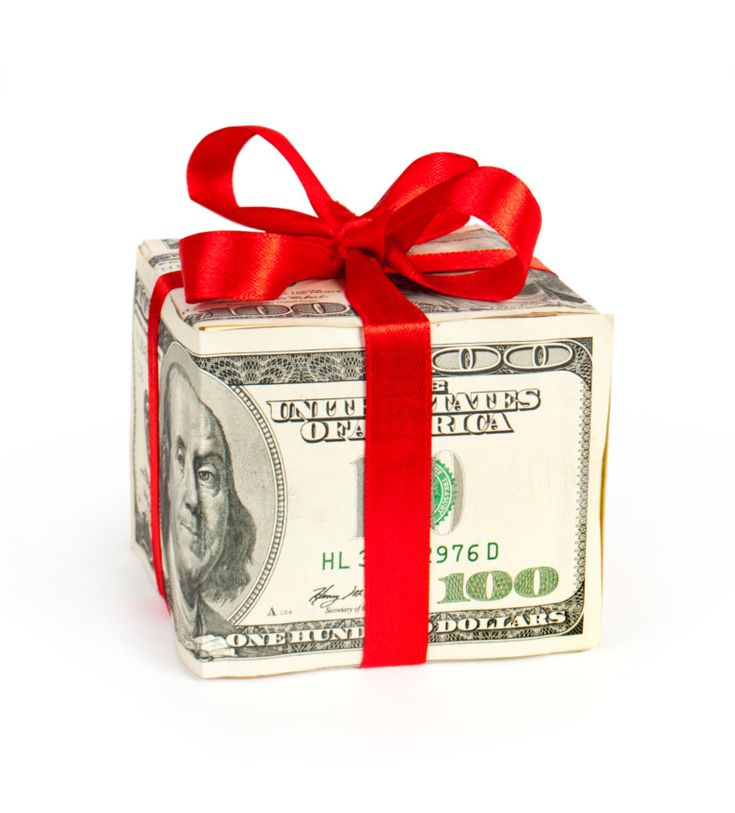 money wrapped in red ribbon on top of a white box with one hundred dollar bill