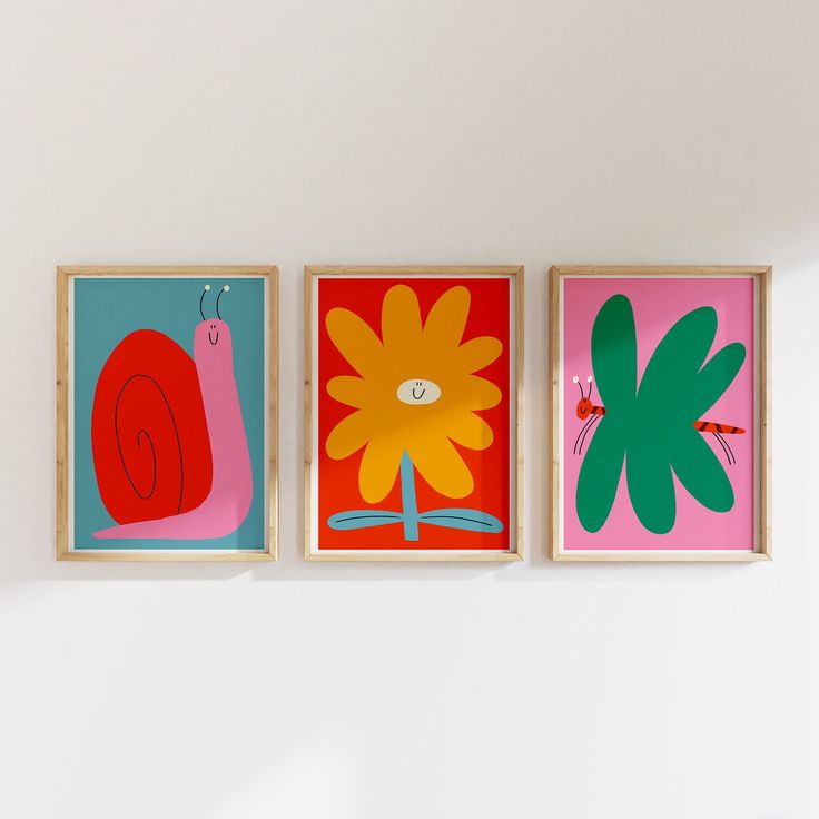 three colorful paintings hang on the wall next to each other