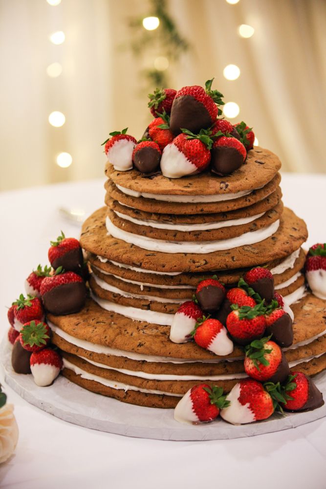 a large stack of cookies with strawberries on top