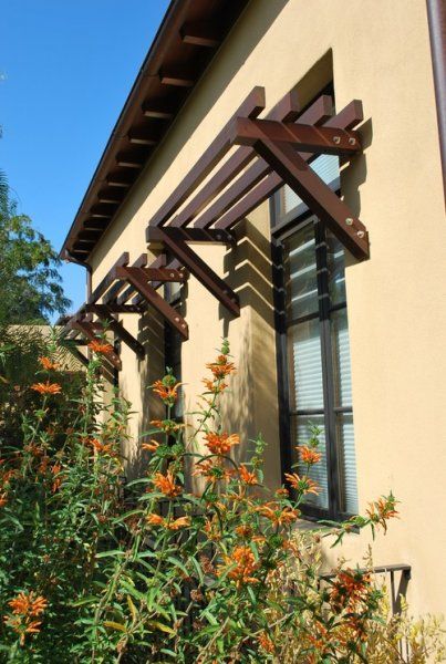 an outside view of a house with flowers in the foreground