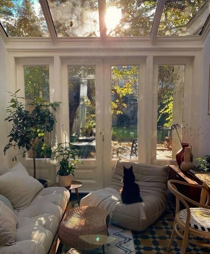 the sun shines through the glass roof in this living room