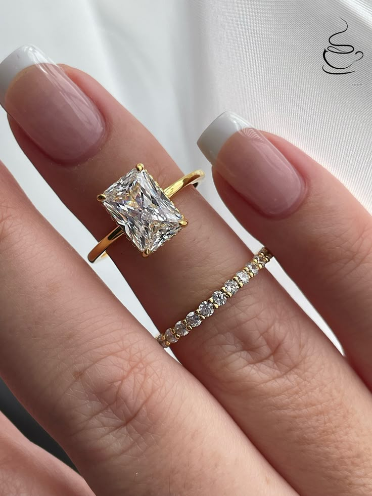 New In! Fall 2023 The Grace +The Scarlett  💎This beautiful bridal set features 3CT(7mm*10mm) radiant cut stone with hidden halo underneath it on a 1.7mm 18K yellow gold over Sterling Silver band and a complimentary 2mm half eternity band. 💎Made of high quality sterling silver and  heavy plated with Gold it will not rust or turn your finger green. Please be aware that plated jewelry can wear off over time, if this is a concern we would suggest going with the sterling silver ring plated with Rhodium.  Please note: Even though we apply thick layer of gold we strongly recommend to avoid lotions, harsh chemical and water to make sure gold stays on.  💎Will come in a box ready for a Gift  Will be shipped within 1-2 business days from Los Angeles CA -------------------------------------------- Radiant Wedding Rings, Engagement Ring With Hidden Halo, Gold Band Engagement Rings, Radiant Engagement, Pretty Engagement Rings, Dream Wedding Ring, Ring Cuts, Radiant Cut Engagement Rings, Ring Inspo