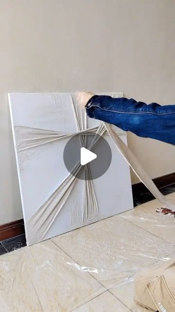 a person standing on top of a tile floor next to a white box with an opening in it