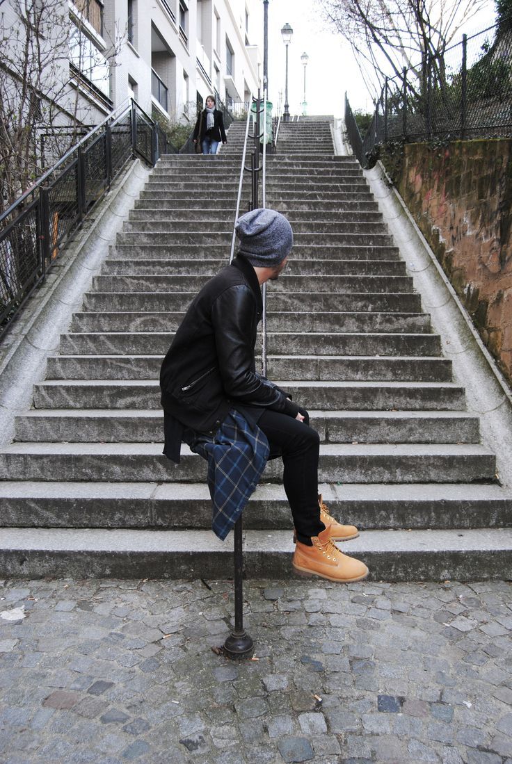 a man sitting on top of a set of stairs