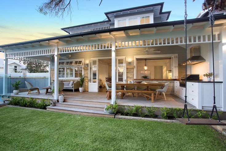 a white house with a porch and covered patio