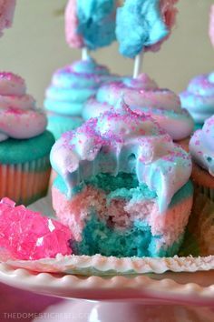 cupcakes with frosting and sprinkles are on a plate