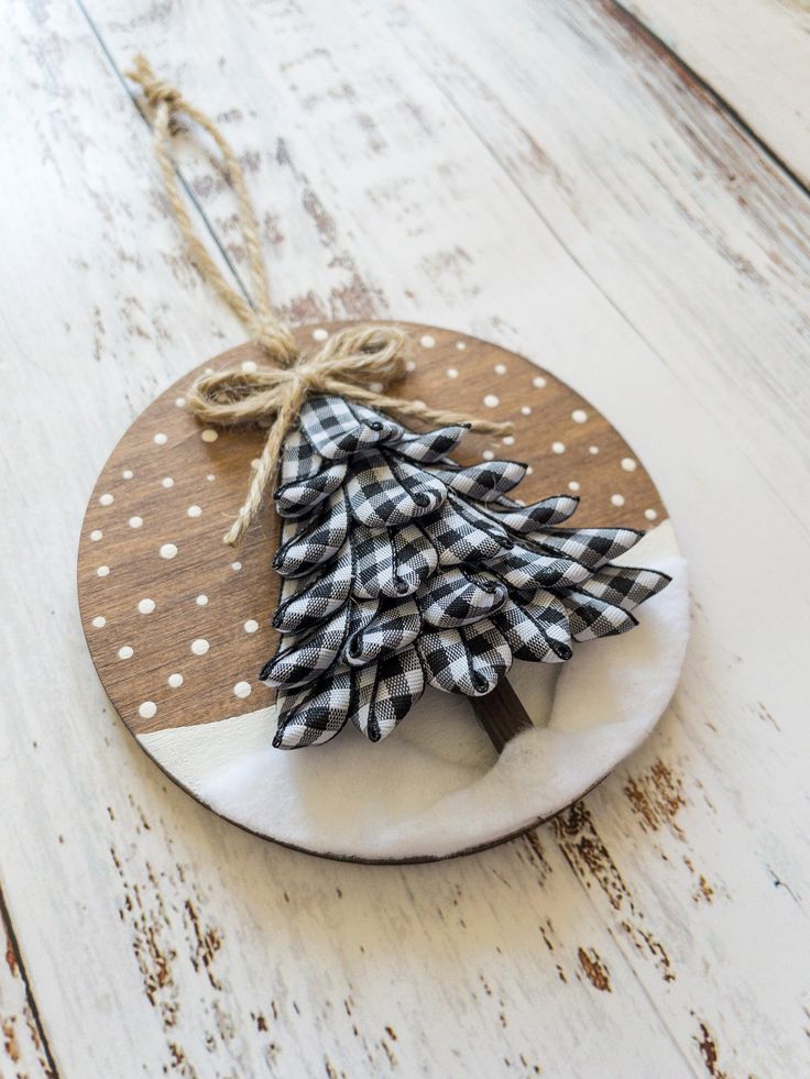 a wooden ornament with a christmas tree on it