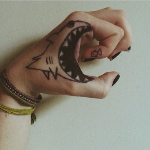 a woman's hand with a tattoo on it and a wristband around her