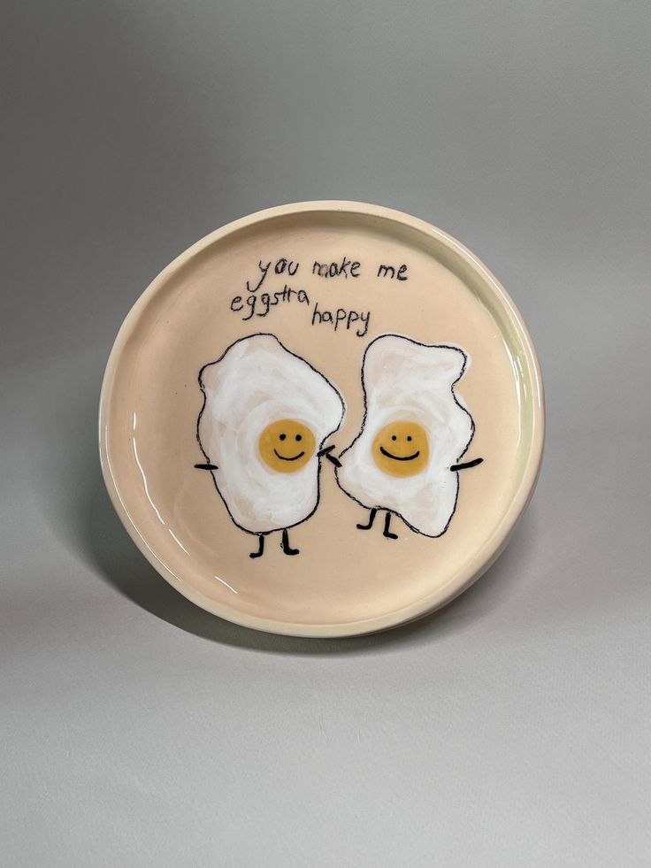 two fried eggs on a plate with the words you make me happy