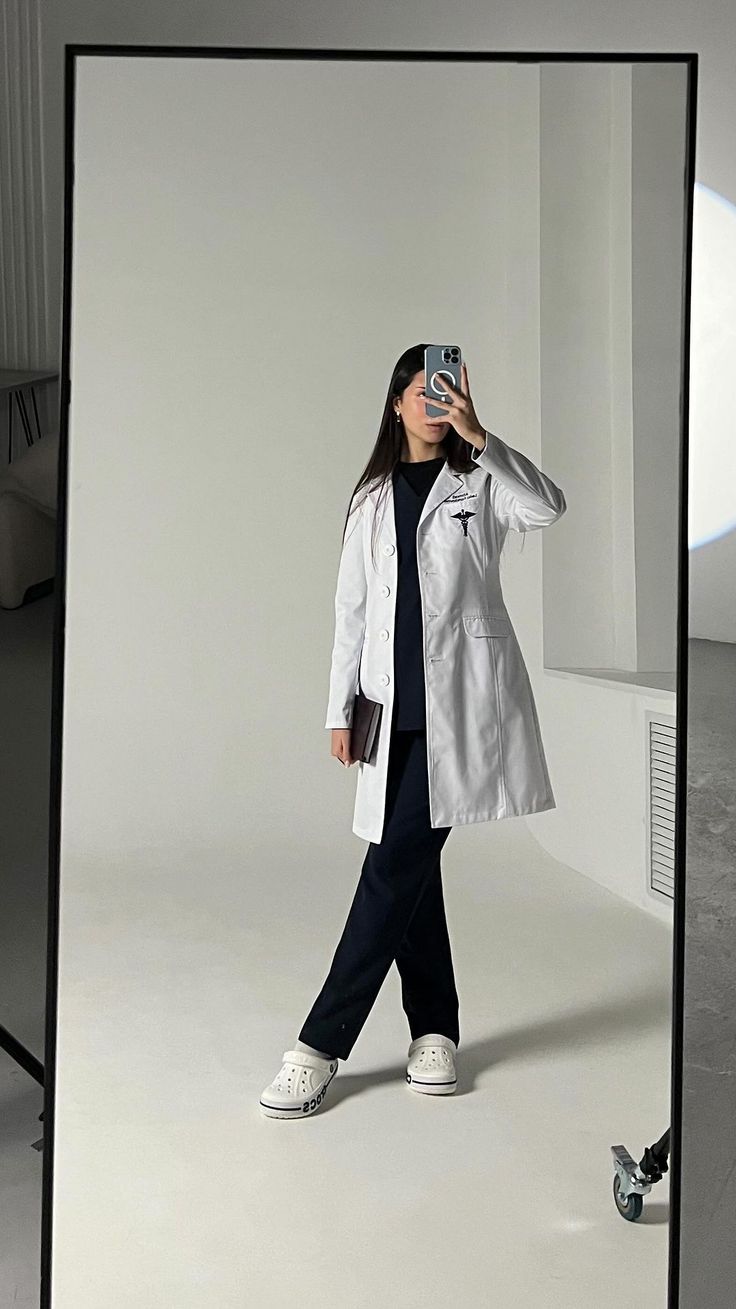 a woman is taking a photo with her cell phone while standing in front of a mirror