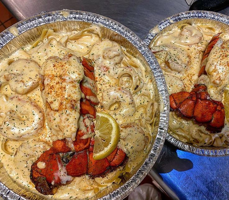 two metal pans filled with lobster and pasta