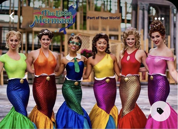 the mermaids are all dressed up in different colors and sizes, posing for a photo