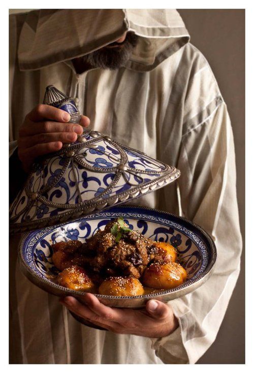 a man holding a dish with food in it