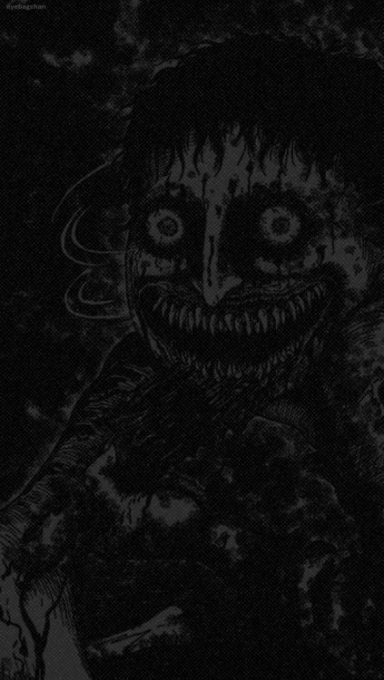 an evil clown with his mouth open in the dark