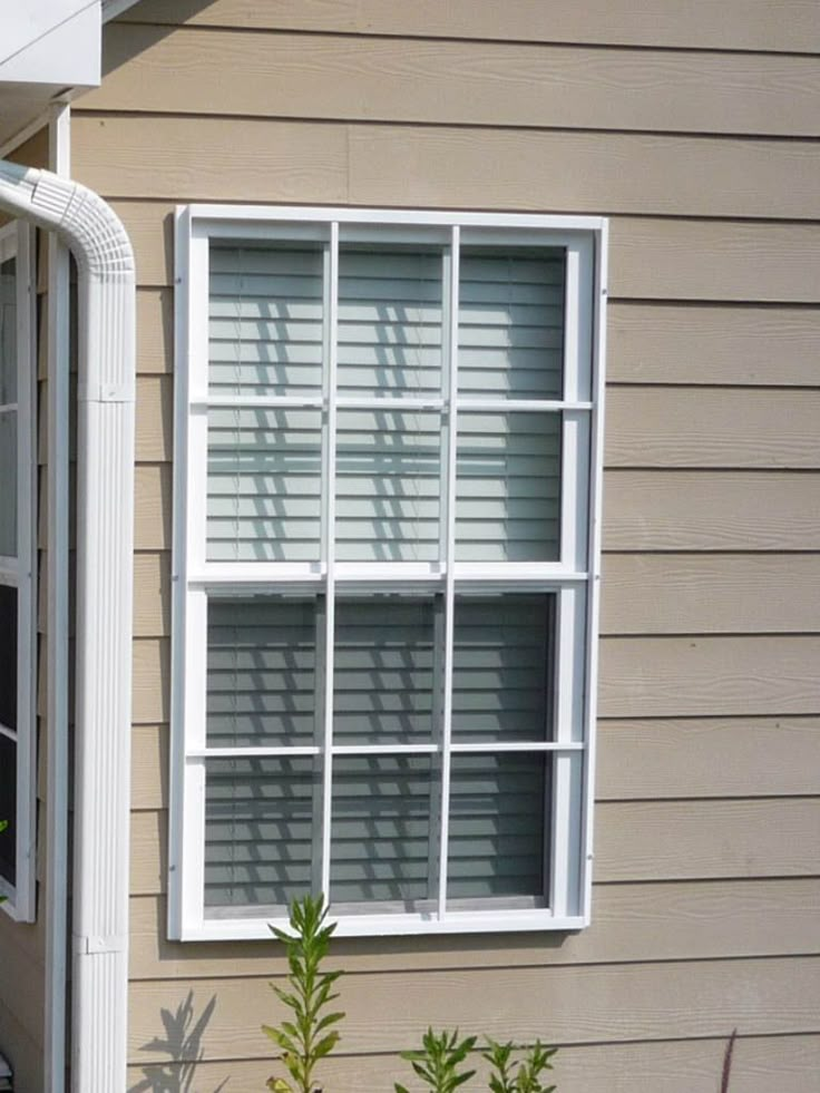 a cat sitting in the window sill of a house