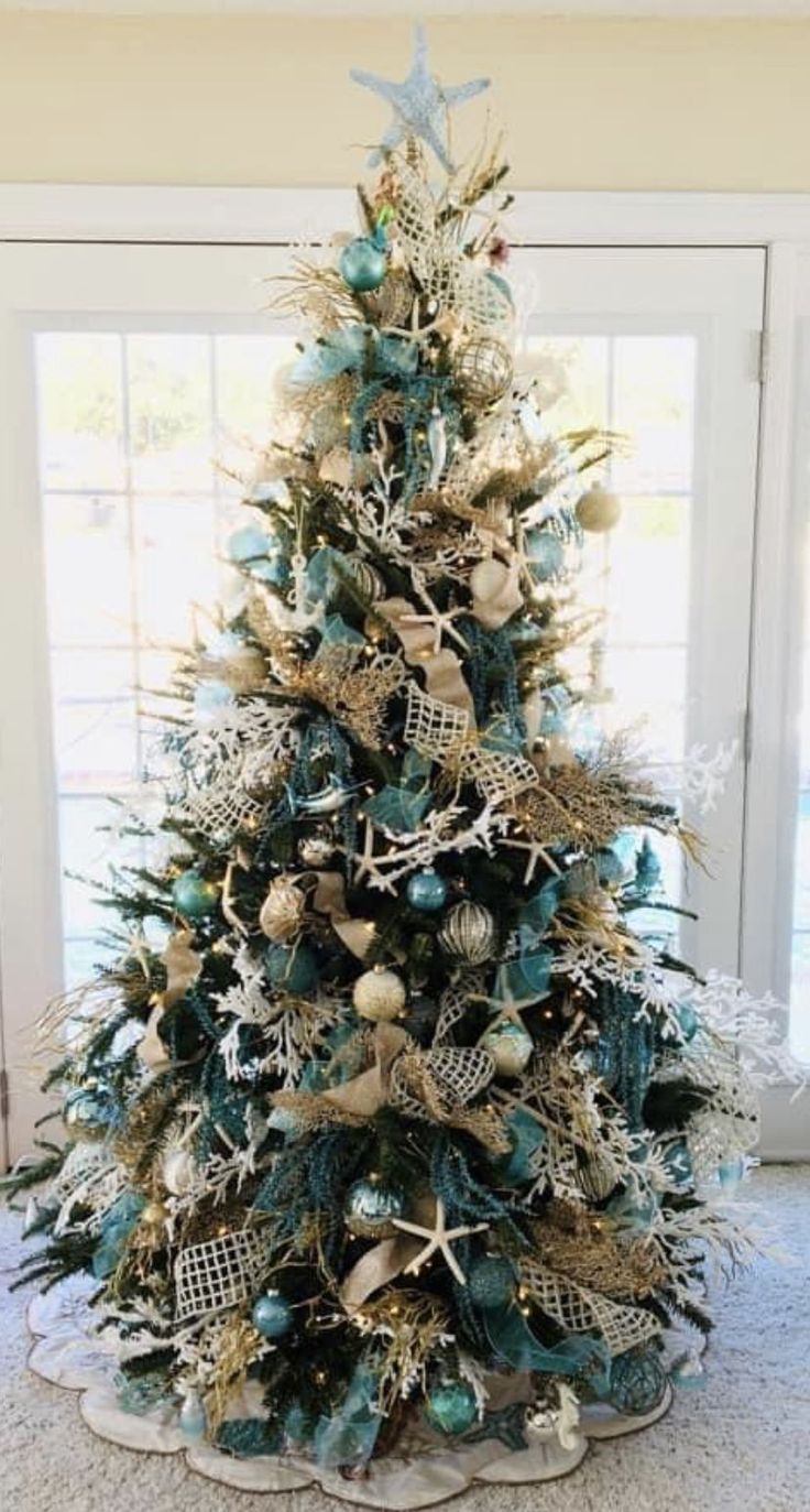 a christmas tree decorated with blue and gold ornaments