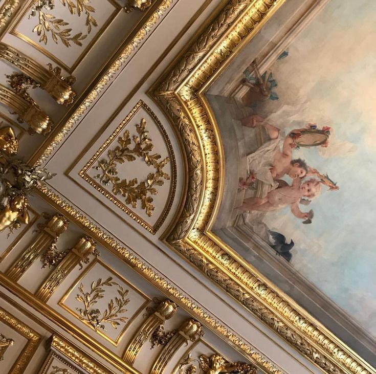 the ceiling is painted with gold and white