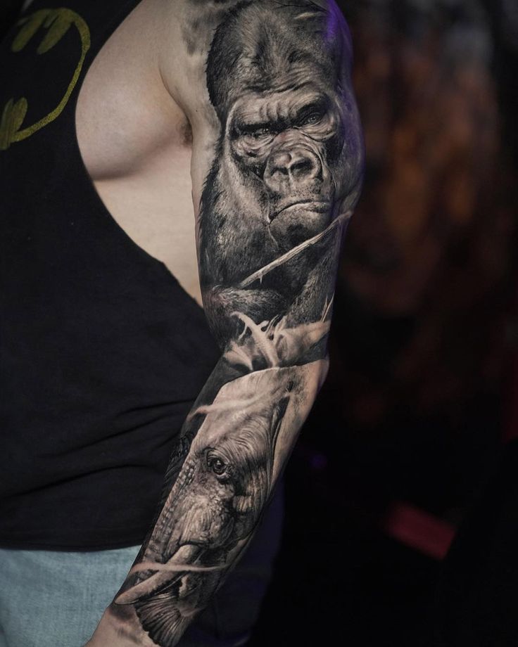 a man with a gorilla and elephant tattoo on his arm