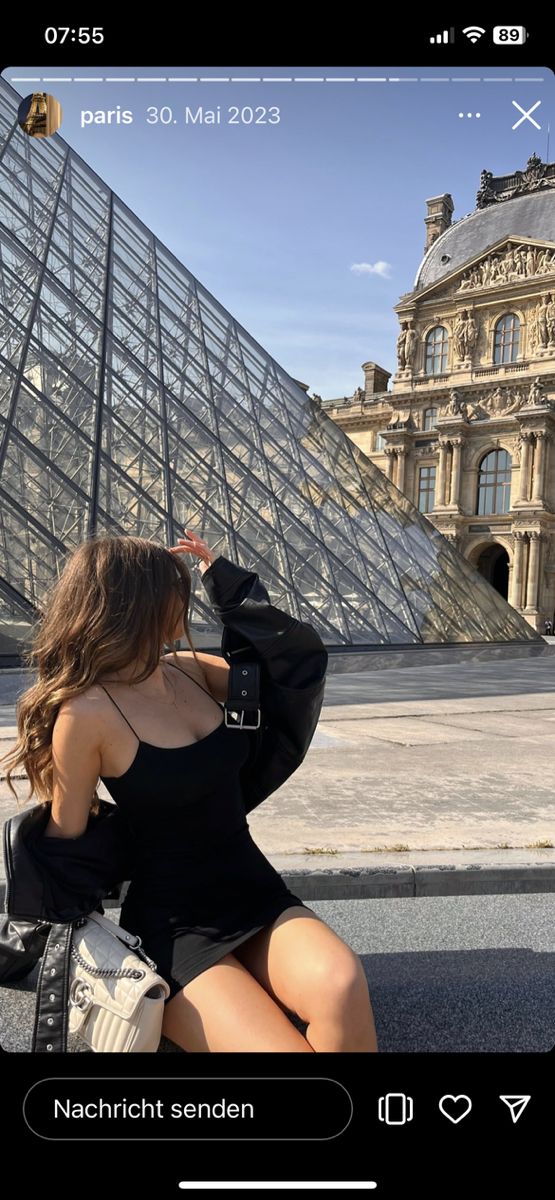 a woman is taking a selfie in front of the pyramid