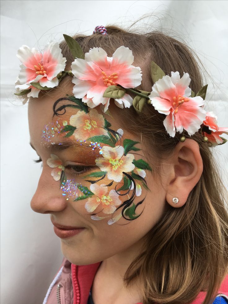 a girl with flowers painted on her face