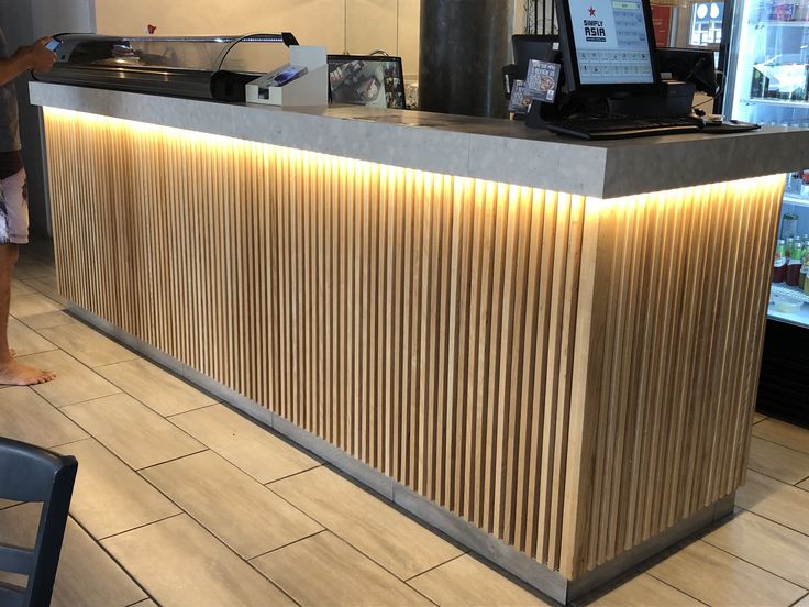 a woman standing in front of a counter at a restaurant